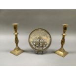 A pair of early 19th century brass candlesticks with baluster columns and stepped square base,