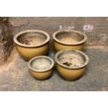 Five buff coloured garden planters or circular form approximately 26cm high and two smaller at