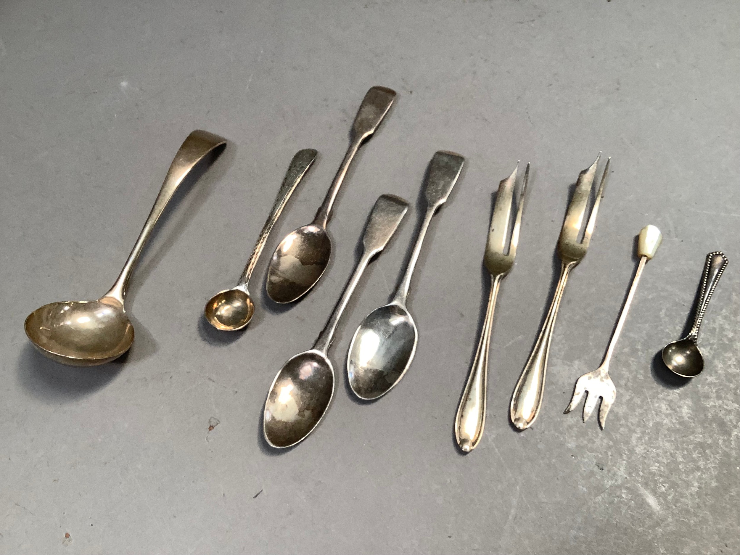 A collection of silver teaspoons, mustard spoons and cake forks, c. 1830-1930, total approx.