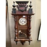 A Victorian mahogany wall clock having a white enamelled two part dial, 8 day striking movement,