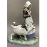 A Royal Copenhagen group of a girl with goats, printed and painted mark to underside, 25cm high x