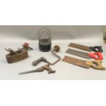 A vintage garden sprinkler, a bit and brace, plane, smelting pot, saws etc