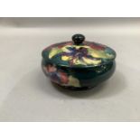 A Moorcroft circular bowl and cover with knopped finial, tube lined and painted with the hibiscus