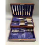 An oak canteen of silver plated cutlery with ivorine handles, drawer to base, mixed designs