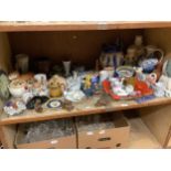 A large quantity of ornaments including vases, jugs, shaving mugs, figures of monks and other items,