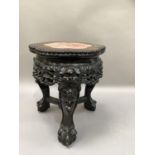 A Chinese hardwood and marble inset urn stand circular scalloped outline on three carved legs,