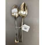 A pair of George III silver dessert spoons with beaded edge and engraved with a stag crest, London