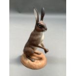 A bisque figure of a hare on oval base, produced for the WWF by Renaissance, England, painted