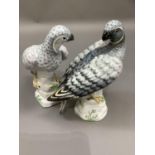 A pair of Crown Staffordshire figures of blue hawks painted by W R Tipton and designed by M