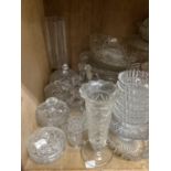 A large quantity of moulded, cut, etched glassware including comports, bowls, decanters, vases,