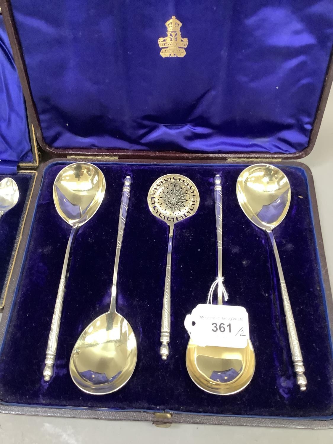 An Elkington & Co set of four silver gilt fruit spoons and a sugar sifting spoon, no assay mark,