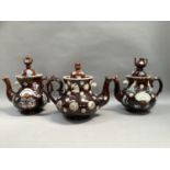 Three barge ware teapots, two with teapot finial, one with acorn finial and all of typical