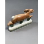 A Rye Pottery running hare on bocage base, pottery mark and monogram for SL to underside, 19cm