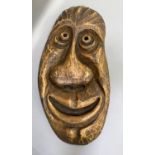 An outsized carved wooden face mask by A Reichlin Luzerne, 81cm high by 40cm wide