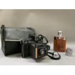 A polaroid land camera 'Super Colour Swinger' in original case together with a spirit flask and