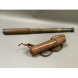 A brass four drawer telescope in leather case initialled KF, closed measurement 27.5cm long