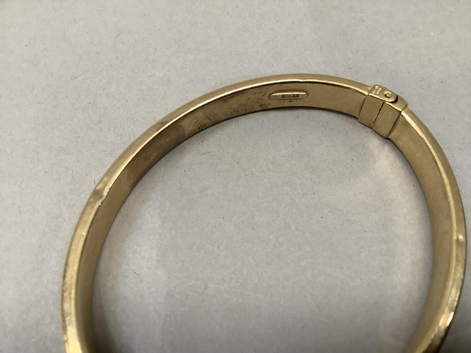 A stiff hinged bangle, concave hollow tube in yellow metal (tests as 9ct gold), approximate weight - Image 2 of 3