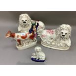 A pair of Staffordshire pottery lions with inset eyes; a cow, calf and farm boy group and a