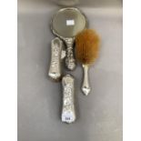 A pair of Edward VII silver backed clothes brushes and a matching hair brush, Birmingham 1904,