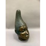 A ceramic bust of tribal female, polished bronze-effect and verdigris finish, with elaborate head-