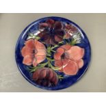 A large Moorcroft pottery charger tube lined and painted in the Anemone pattern in shades of