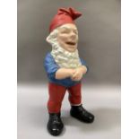 A vintage garden gnome painted in red, white, blue and black, measuring 18.5cm