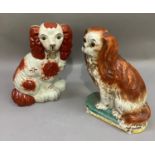 An early 20th century Staffordshire spaniel dog with glass eyes, together with a reproduction