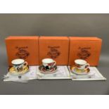 Three reproduction Clarice Cliff cups and saucers from Cafe Noir range in Red Autumn, Coral Firs and