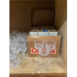 A set of twelve cut glass hock glasses in original packaging together with cut and plain glass