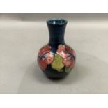 A Moorcroft vase painted and tube lined with the hibiscus pattern in deep rose, pink, yellow,