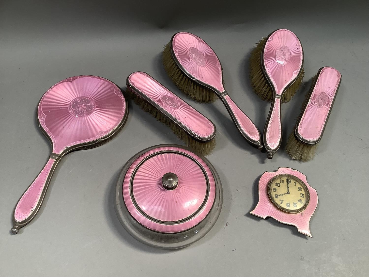 A George V silver and pink enamelled dressing table set with hallmarks for London 1926, 27 and 1930,