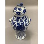 A Chinese blue and white vase and domed cover with dog of fo finial, the baluster body with mask and