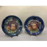 A pair of Moorcroft pottery plaques tubelined and painted with the Finches and Fruit pattern on a