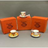 Three reproduction Clarice Cliff cups and saucers Cafe Noir range in Windbells, Coral Firs and