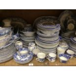A large quantity of blue and white ware including meat dishes, tureens, bowls and plates in Yuan