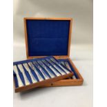 A late Victorian mahogany canteen containing a set of eighteen silver plated fish knives with beaded