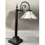 A pale pink and black metal table lamp with arched arm, 48.5cm high