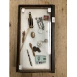Items of bijouterie including coins, sherry ladle, magnifying glass, bottle etc, all in glazed case