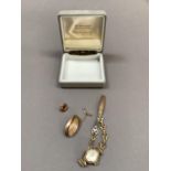 A Victorian hair set brooch in an oval faceted rolled gold surrounded together with a George V