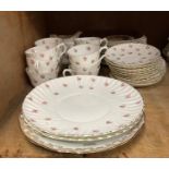 A tea service of rosebud decoration for 12, including 12 cups, 12 saucers, 12 tea plates, 2 bread