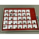 Thirty-two late Roman coins housed in lindner tray