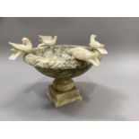A pedestal bowl with Pliny doves perched on the rim, alabaster, approximately 31cm diameter by