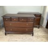 A pair of Stag Minstrel 3 height chest of drawers, each with 4 small drawers above 2 long drawers
