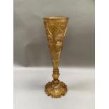 A large 19c Bohemian amber glass vase of panelled and tapered form on a baluster stem and circular