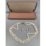 A cultured pearl necklace, the twin string of 6mm pearls fastened with 9ct gold snap, approximate