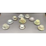 A quantity of specimen cups and saucers including two trios, one by Royal Crown Derby of Woodlands