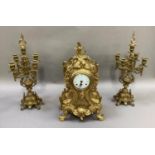 A gilt metal cased clock garniture by Franz Hermle, the Rococo style clock with enamelled dial,