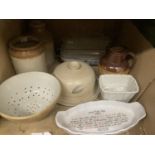 A pair of stoneware storage jars, pottery colander, cheese dish, Doulton Lambeth Toby jug, jelly