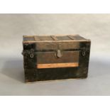 A turn of the century canvas and metal panelled trunk with wooden ribbing, side carrying handles and