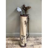 A golf bag and eight clubs including woods, irons and a putter